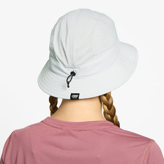 back view of ciele athletics GOBucket Comp Athletics unisex running bucket hat in light grey color on a model