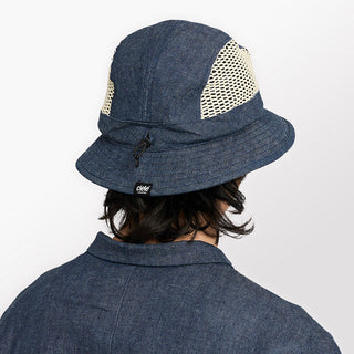 back view of ciele athletics GOBucket unisex running bucket hat from the Lifestyle Edition collection, in denim indigo color, on a model