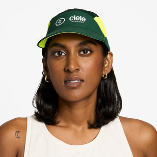 front view of the ciele athletics FTSCap unisex running hat with a curved brim in emerald color, on a model