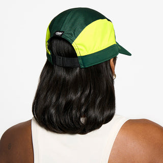 back view of the ciele athletics FTSCap unisex running hat with a curved brim in emerald color, on a model