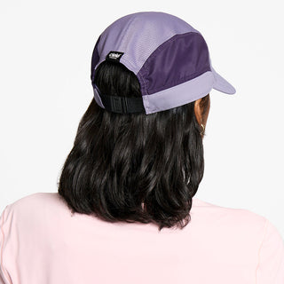 back view of the ciele athletics FTSCap unisex running hat with a curved brim in light grape color, on a model