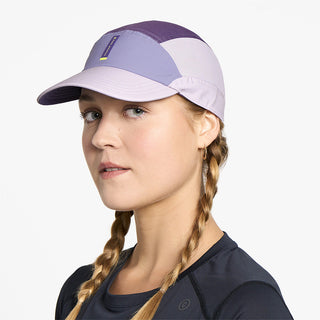 side view of ciele athletics FSTCap SC Comp Iconic VC unisex running hat in light grape color on a model