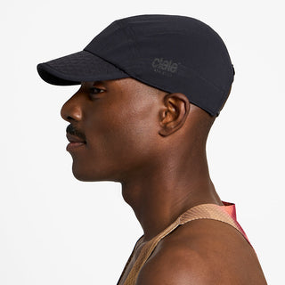 side view of ciele athletics FSTCap unisex running hat from the Elite collection in shadowsphinx color, on a model