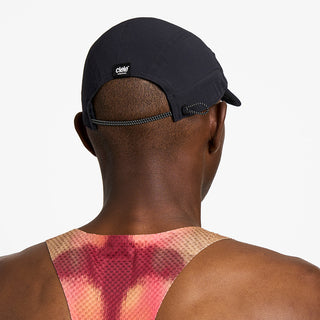 back view of ciele athletics FSTCap unisex running hat from the Elite collection in shadowsphinx color, on a model