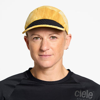 front view of ciele athletics FSTCap unisex running hat from the Elite collection in sphinx color, on a model