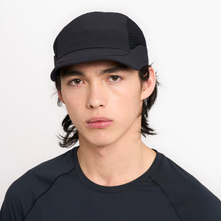 front view of ciele athletics new FSTCap ethereal unisex running hat from the Elite collection in shadowcast color, on a model