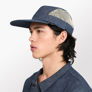 side view of ciele athletics GOCap longbrim unisex running hat with longer brim from the Lifestyle Edition collection, in denim indigo color, on a model