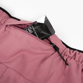 close view of the zippered back pocket of the ciele athletics DLYShort 4 inch with a long brief in deco rose color