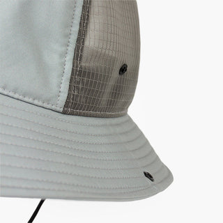 closeup view of the ciele athletics TRLBucket unisex running bucket hat side button closure in neutral grey color