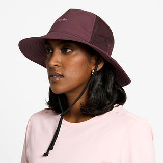 side view of the ciele athletics TRLBucket unisex running bucket hat in dark wine red color, on a model